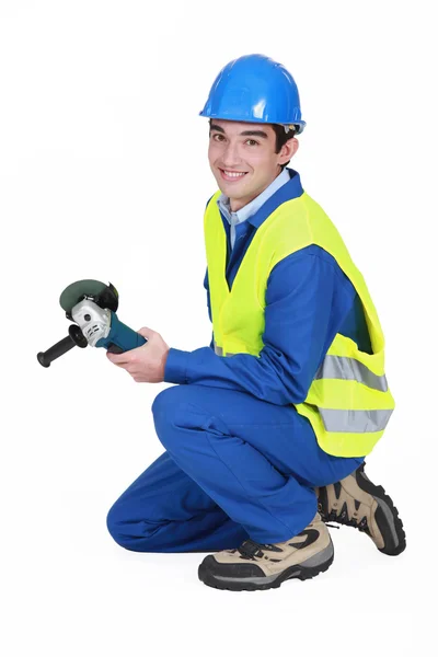 A male construction worker with a grinder. — Stock Photo, Image