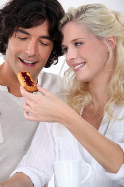 Couple eating jam on toast clipart