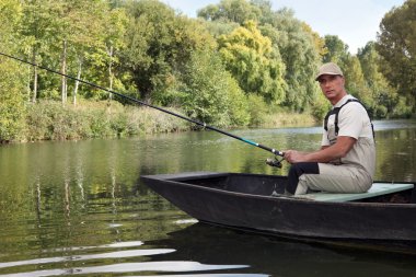 Man fishing on a lake clipart