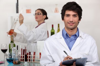 Two scientists in wine testing facility clipart