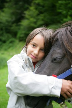 Child stroking horse clipart