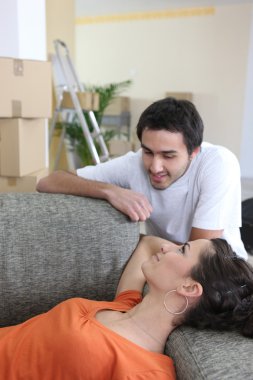 Couple relaxing on moving day clipart