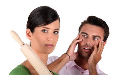 Angry woman threatening man with rolling pin clipart