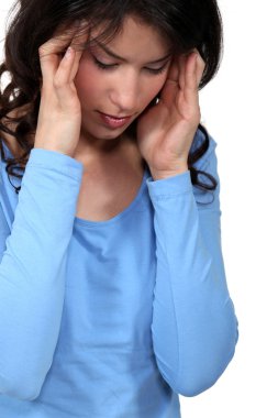 Woman suffering from a headache clipart