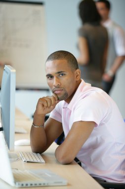 Casual worker thinking whilst sat at computer clipart