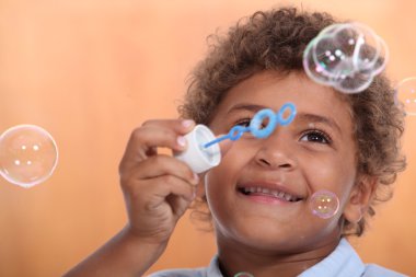 Boy blowing bubbles clipart