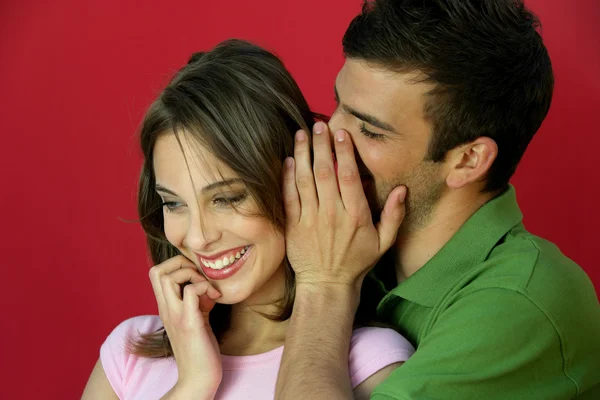 Man telling secret to woman — Stock Photo, Image