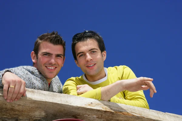 stock image Two male friends stood on balcony
