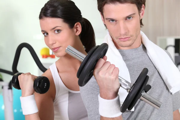 Young woman and young man healthy with barbells — Stock Photo, Image