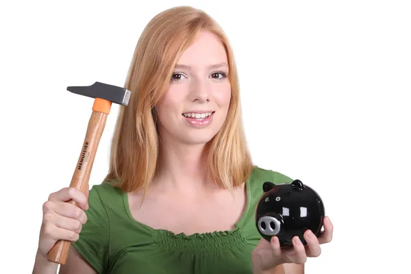 Blonde with piggy-bank and hammer — Stock Photo, Image