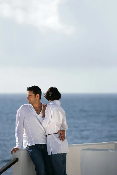 Embraced couple standing on a terrace — Stock Photo, Image