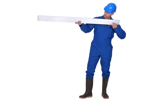 Tradesman holding a girder — Stock Photo, Image