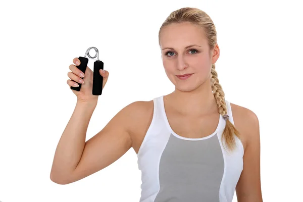 Young woman holding hand grippers — Stock Photo, Image