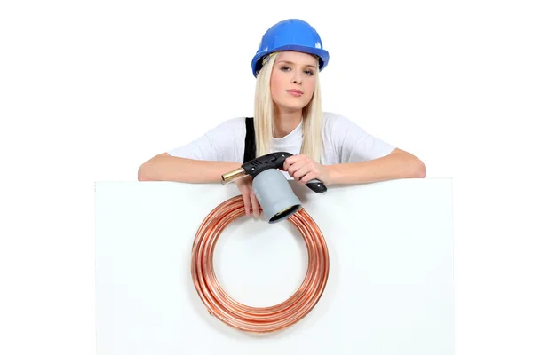 Female plumber with advertising board — Stock Photo, Image