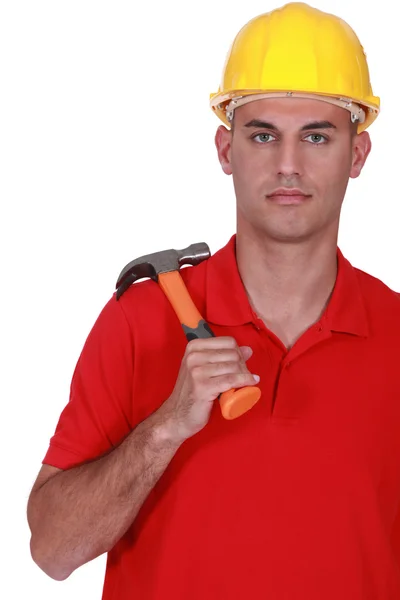 Serious handyman holding hammer — Stock Photo, Image