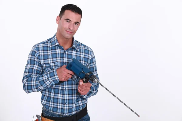 Man with a masonry drill Stock Picture