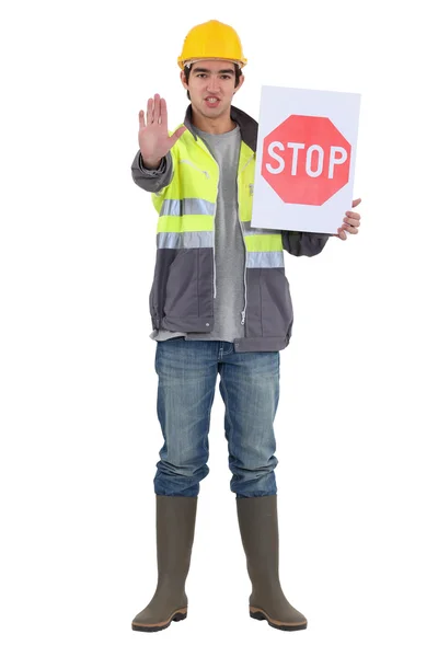 Craftsman holding a stop sign — Stock Photo, Image