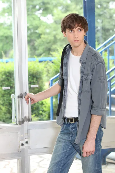 Male student opening door — Stock Photo, Image