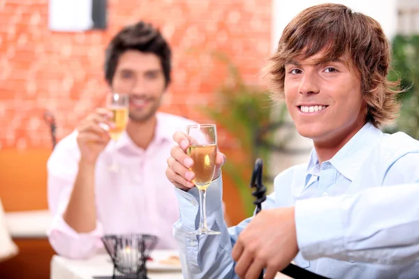 Two businessmen drinking champagne in restaurant — Stock Photo, Image
