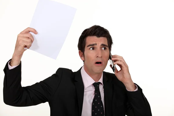 Businessman having a surprising news on his cell — Stock Photo, Image