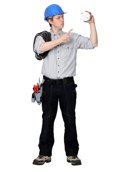 Tradesman pointing to a smoke detector — Stock Photo, Image