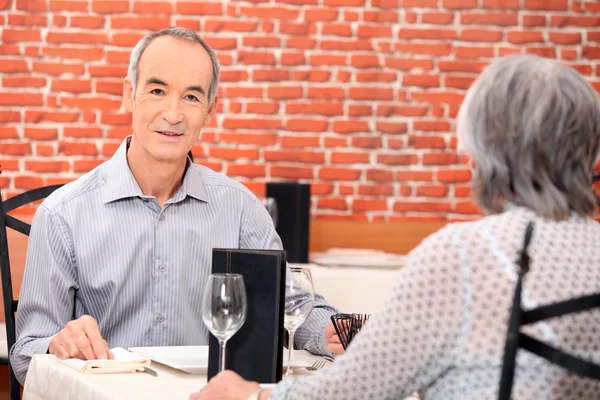 レストランの食事を食べて年配のカップル — ストック写真
