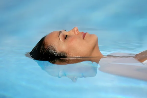 Mulher com os olhos fechados numa piscina — Fotografia de Stock