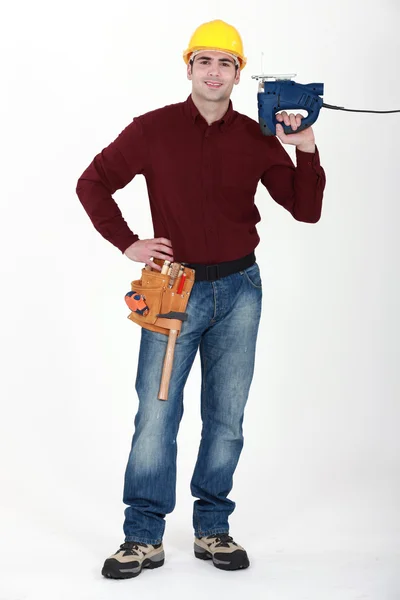 Worker with an electric jigsaw — Stock Photo, Image