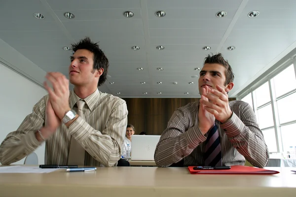 Affärsmän satt på deras skrivbord som applåderar — Stockfoto