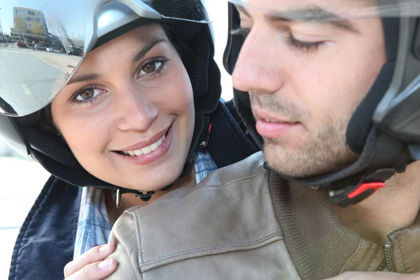 Smiling couple on a motorbike — Stock Photo, Image