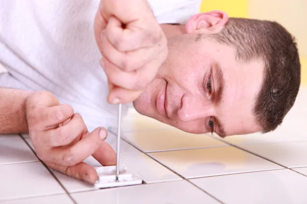 Handyman screwing an electrical outlet — Stock Photo, Image