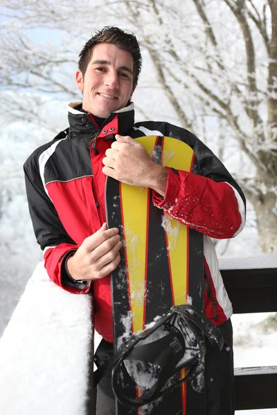 Snowboarder standing on his balcony — Stock Photo, Image