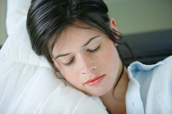 Young woman resting on a sofa — Stock Photo, Image