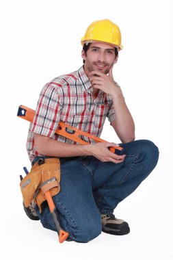 Kneeled handyman. clipart