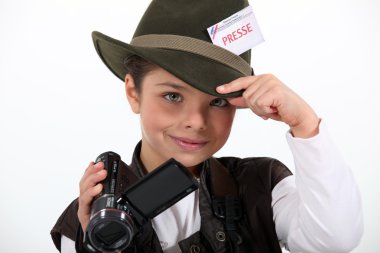 Little girl taking a camera and wearing a costume of journalist clipart