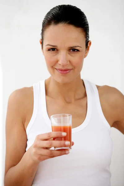 Brunette holding glass of tomato juice — Stock Photo, Image