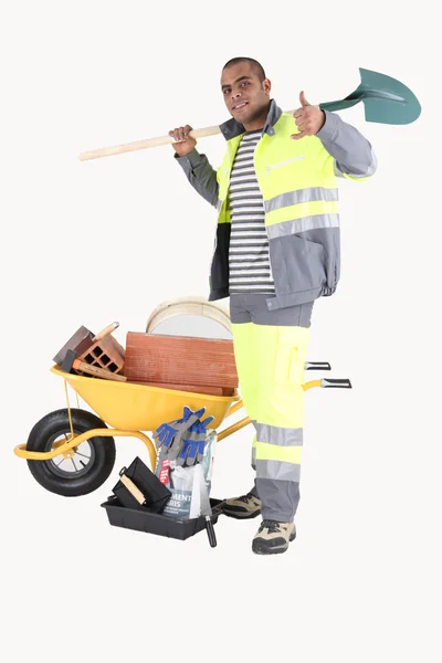 Builder with a barrow of bricks — Stock Photo, Image