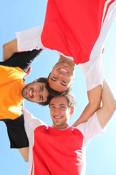 Sports team with heads together — Stock Photo, Image