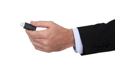 Man holding a USB key. clipart