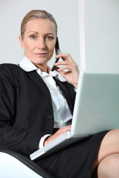 Donna d'affari al telefono con computer portatile . — Foto Stock