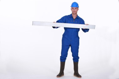 Tradesman holding up a steel girder clipart