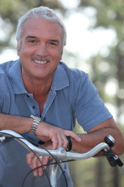 Man with push bike clipart