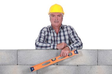 Stonemason holding a bubble level clipart