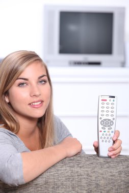 Young girl holding remote control clipart