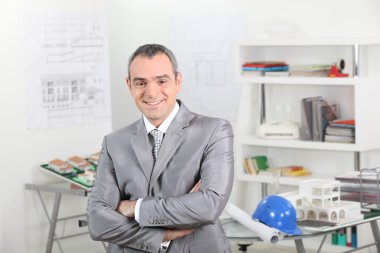 Smiling architect in office clipart