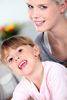 Mother and daughter sharing a moment of tenderness clipart