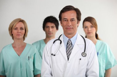 Male doctor and his nursing team clipart