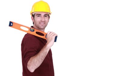 Tradesman carrying a spirit level clipart