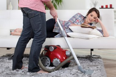 Man using vacuum cleaner clipart