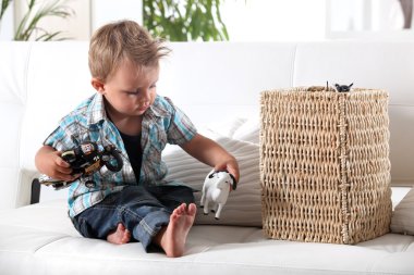 Young boy playing with his toys clipart